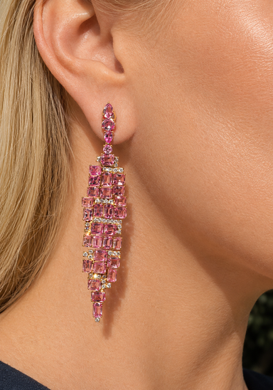 Blonde woman wearing large pink stone and diamond dangle earring