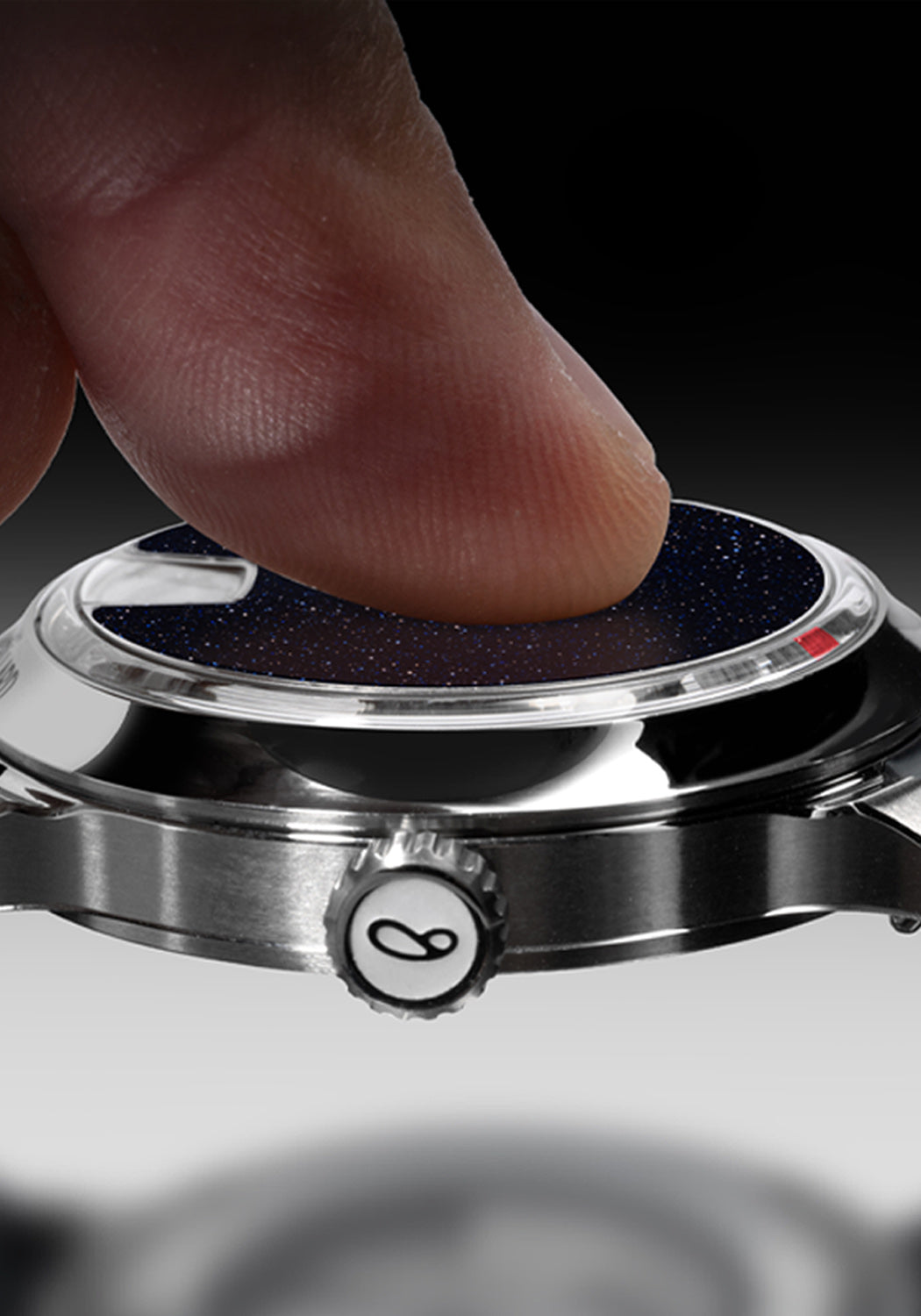 Close-up of finger touching the Blue-Aventurine Dial on the Sartory Billard Blue Aventurine