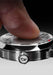 Close up of a finger touching the face of the SB 10 Jumping Hour Meteorite watch.