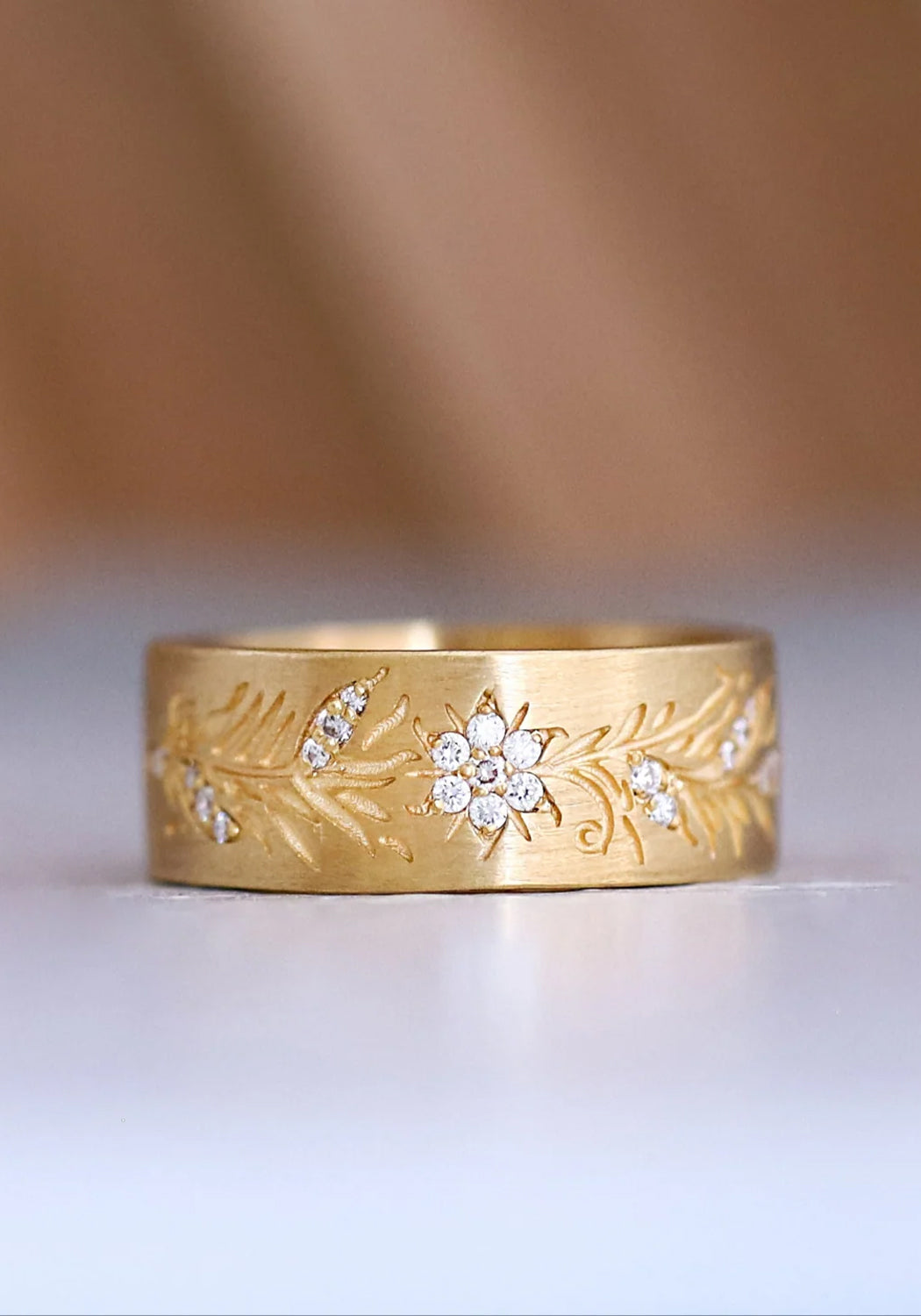 A close up of the Sethi Fleur band shows off clusters of diamonds highlighting the floral design.