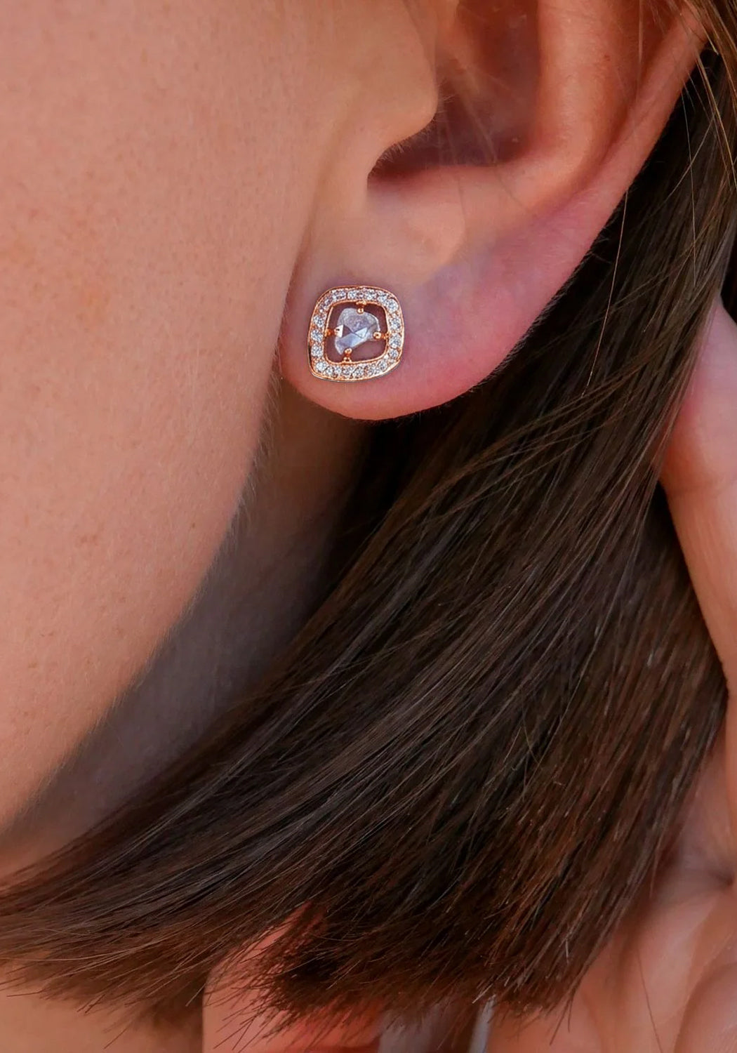 Closeup of a Sethi Couture Logan 18K Rose Gold Halo Rose Cut Diamond Stud Earring on a model's ear
