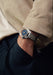 Singer Reimagined 1970 DualTrack Cobalt Blue on a man's wrist | OsterJewelers.com