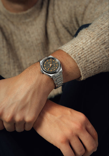 The Singer Reimagined 1970 DualTrack Espresso shown on a man's wrist | OsterJewelers.com