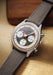 The Singer Reimagined Heritage V72 Stone-Gray Steel shows off 3 counters against a stone grey dial