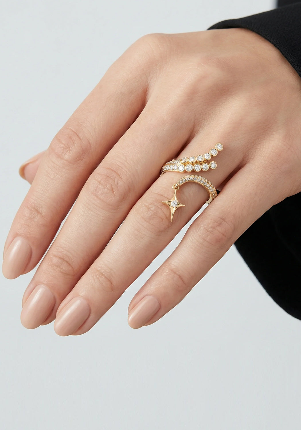 Shown on a mode's hand, the trailing design of the Sybarite Falling Star Ring can be worn up or down
