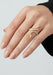 Shown on a mode's hand, the trailing design of the Sybarite Falling Star Ring can be worn up or down