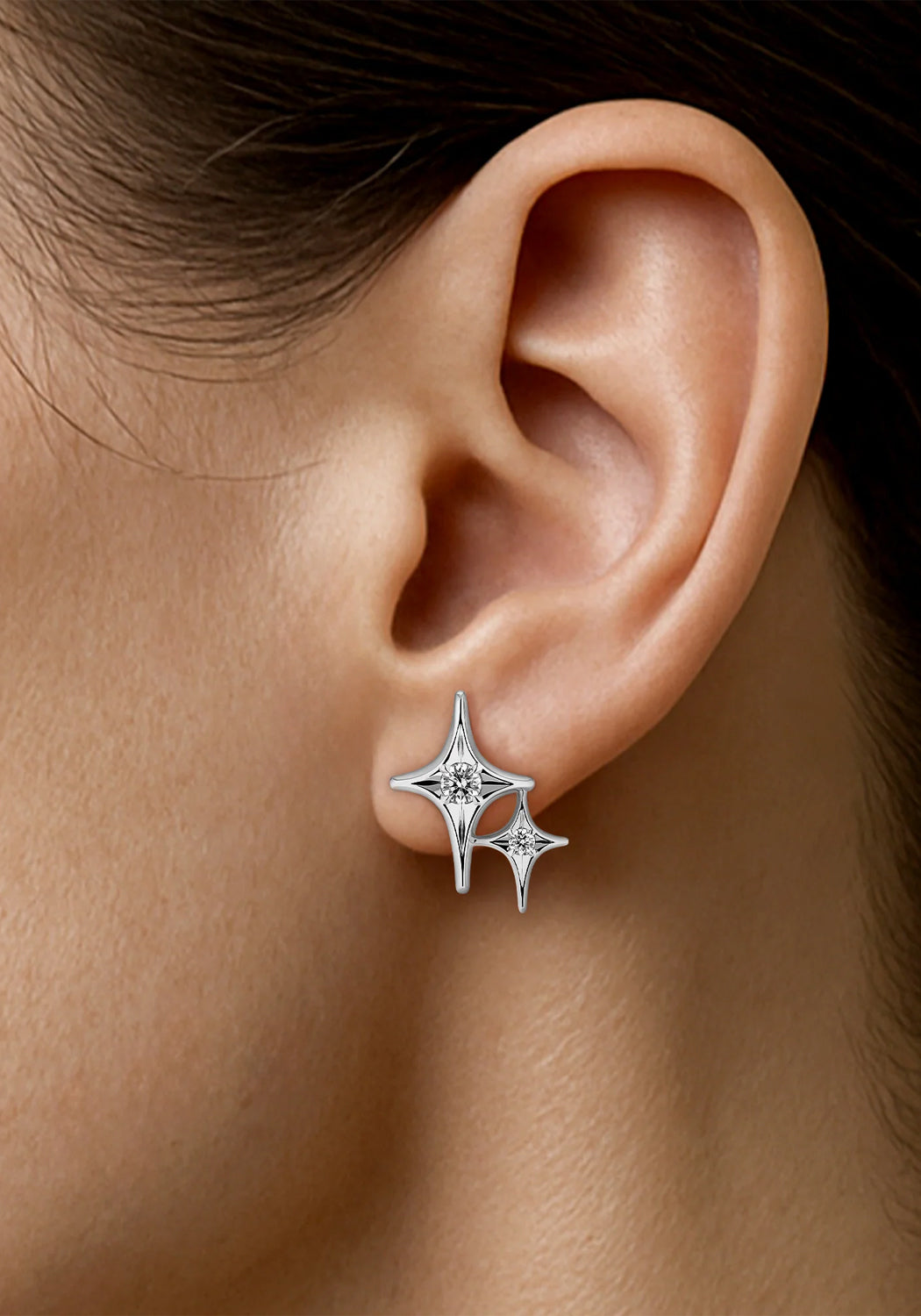 Closeup of a Sybarite Falling Stars 18KWG Diamond Double Star Stud Earring on a model's ear