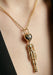 The Sybarite She’s an Alien Pendant Necklace features large alien head with sapphire eyes and star