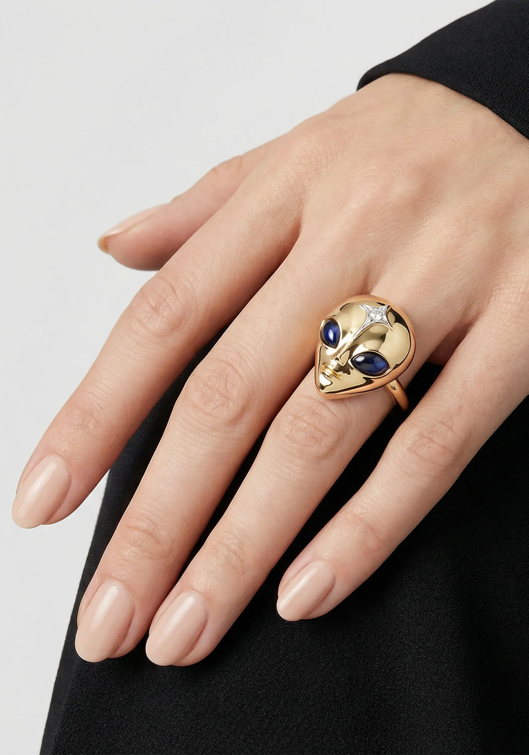 The eyes of the Sybarite She's an Alien Ring are made of sapphires. Shown on a model's hand.
