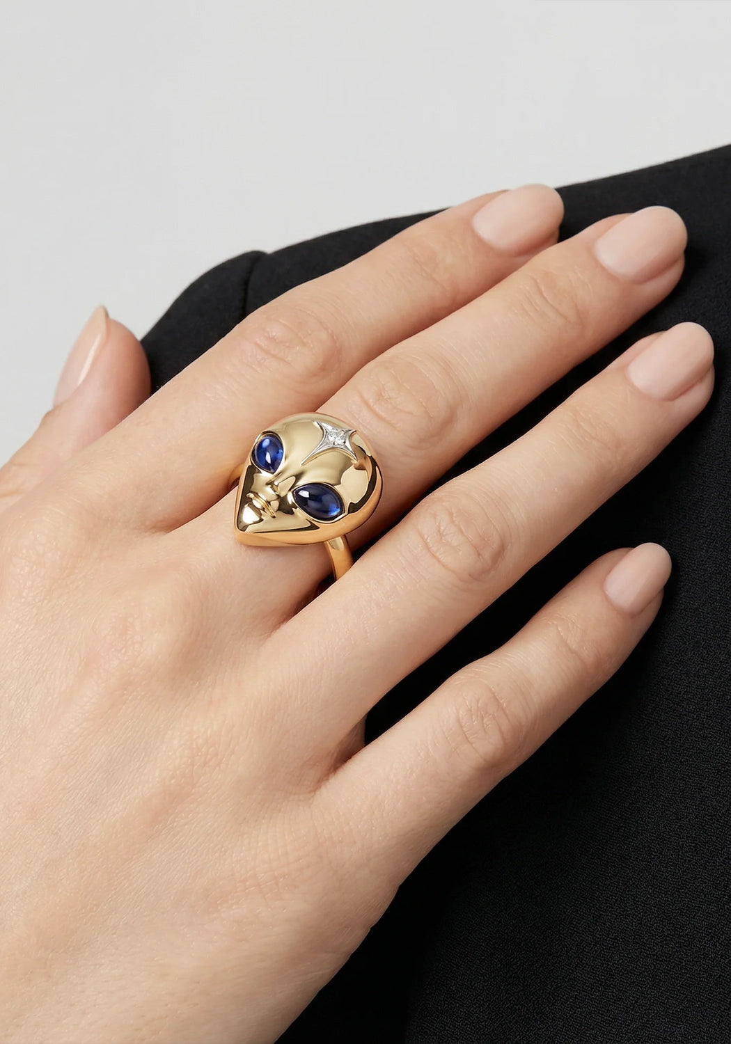 The eyes of the Sybarite She's an Alien Ring are made of sapphires. Shown on a model's hand.