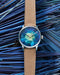 Louis Erard Marqueterie de Paille shown against the blue straw used in crafting the marquetry dial.
