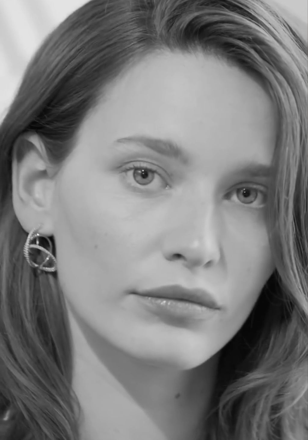 Ole Lynggaard 18KYG Twisted Love Bands Pavé Diamond Earrings in B&W on brunette model

